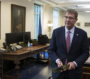 Secretary of Defense Ash Carter holds a Marine Corps Ka-Bar knife while being interviewed in his Pentagon office, Wednesday, Jan. 18, 2017, in Washington. (AP Photo/Cliff Owen)