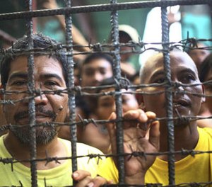 Filipino inmates remain in their cell at the North Cotabato District Jail in Kidapawan city, Cotabato Province, southern Philippines, after a massive jailbreak Wednesday, Jan. 4, 2017.