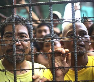 Filipino inmates remain in their cell at the North Cotabato District Jail in Kidapawan city, Cotabato Province, southern Philippines, after a massive jailbreak Wednesday, Jan. 4, 2017.