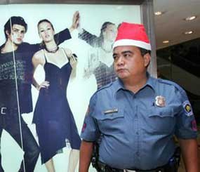 It’s Hanukwaansmas time again. Look at the bright side, unlike Officer Erwin Collao, you don't work for Manila (Philippines) PD and don't have to wear Santa hats on patrol inside a shopping mall. (AP Photo)

