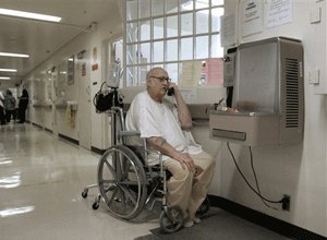 Ron Anderson, a wheel chair bound inmate at the California Medical Facility, in Vacaville, Calif., makes a call from a pay phone Wednesday, April 9, 2008. (AP Photo/Rich Pedroncelli)