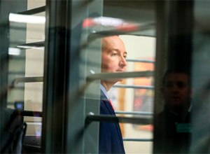 Nebraska Gov. Pete Ricketts is seen through bars during a tour of the Tecumseh State Correctional Institution in Tecumseh, Neb., Tuesday, May 19, 2015.