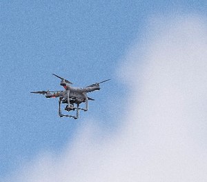 Police officers survey the scene via a drone at a Wells Fargo Bank, Friday, July 7, 2017 in Marietta, Ga.