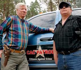Sam Nichols, left, and Glenn Woodbury are part of a newly-formed neighborhood watch that does armed patrols around the rural area to deter crime since budget cutbacks have left the Josephine County Sheriff's Office with just three patrol deputies and limited jail space. (AP Image)
