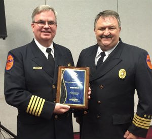 Chip Decker and Rob Lawrence, on behalf of RAA, receive the Dick Ferneau Paid Service of the Year.