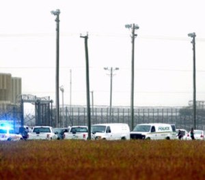 In this Thursday, Oct. 12, 2017 photo, police vehicles are seen outside Pasquotank Correctional Institution in Elizabeth City, N.C. (Thomas J. Turney /The Daily Advance via AP)