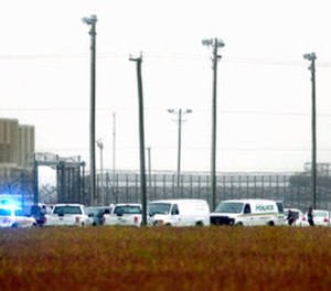 In this Thursday, Oct. 12, 2017 photo, police vehicles are seen outside Pasquotank Correctional Institution in Elizabeth City, N.C.
