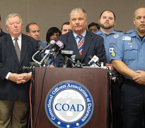 Geoffrey Klopp, center, president of the Correctional Officers Association of Delaware, speaks about a prison uprising Thursday, Feb. 2, 2017, in Dover, Del. Klopp says that he believes the uprising was due to low staffing issues at the 2,500-prisoner James T. Vaughn Correctional Center that have existed for years.