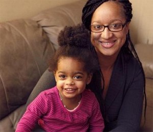 Chanti Carter-Rene sits with her 2-year-old daughter, Angelina, at her father's home in East Orange. Carter-Rene credited her father, East Orange Fire Capt. Larry Carter, for her good deed in returning $3,500 she found on the street in Morristown.