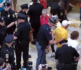 Wisconsin Capital Police arrest people gathered in the state Capitol rotunda for the daily noontime singalong on July 24 in Madison, Wis.