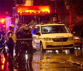 Police cordon off the rear outside an auditorium where a gunman shot and killed at least one person during the Parti Quebecois victory rally  early Wednesday, Sept. 5, 2012 in Montreal.