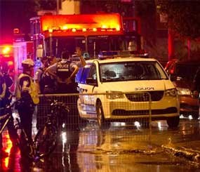 Police cordon off the rear outside an auditorium where a gunman shot and killed at least one person during the Parti Quebecois victory rally early Wednesday, Sept. 5, 2012 in Montreal.