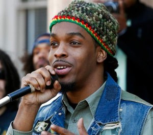 In this Sunday, April 20, 2014, file photo, Jawara McIntosh, son of legendary Reggae icon and a pro-marijuana activist, Peter Tosh, sings a song as he stands with a large gathering in front of the New Jersey Statehouse in Trenton, N.J. (AP Photo/Mel Evans, File)