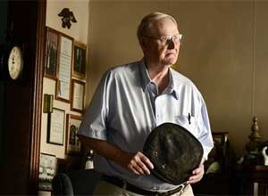 Ray Bogart, a former correction officer taken hostage during the Attica Prison riot, holds what remains of the uniform cap worn during the riot that was recently returned to him, at his home in Auburn, NY, Tuesday, Oct. 7, 2014.