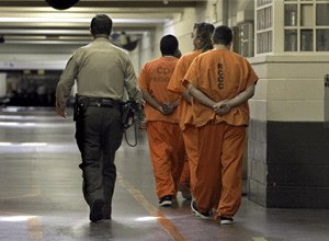 A correctional officer escorts a group of recently arrived inmates through the Deuel Vocational Institute in Tracy, Calif., in this Aug. 3, 2006, file photo. (AP Photo/Rich Pedroncelli)