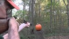 This man carves his pumpkin using his rifle 