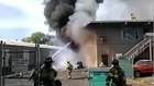 Firefighter falls through roof battling fire