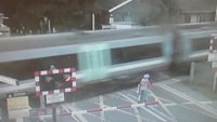 Terrifying near-miss between cyclist and train