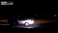 Woman drives off as officer clings to front of car