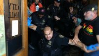 Portland police clash with protesters outside city hall