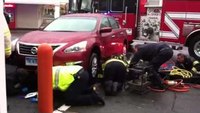 Firefighters rescue man pinned under car