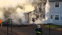 Civilians advance hose lines at fire