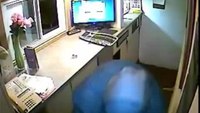 Robber lunges through motel window