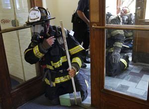 AP Photo/Steven SenneWorcester firefighter Lt. Jeffery Dubeau takes part in a test exercise for safety tracking devices Tuesday on the campus of Worcester Polytechnic Institute.