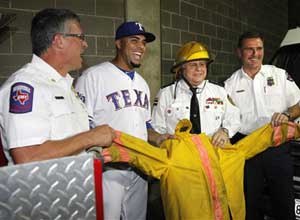AP Photo/Tony Gutierrez
Texas Rangers right fielder Nelson Cruz poses with Arlington FD chief and the Las Matas Santa Cruz fire chief.