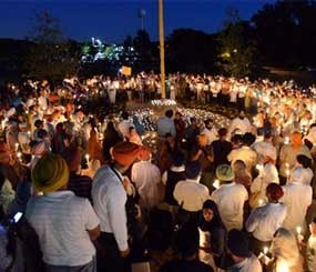 Sikh women and men hold candles during a prayer vigil at the Sikh Religious Society temple in Palatine, Il. on Monday, Aug. 6, 2012. The vigil was held in memoriam of those killed and wounded in a weekend Sikh temple shooting near Milwaukee. (AP photo / Daily Herald, Mark Welsh)