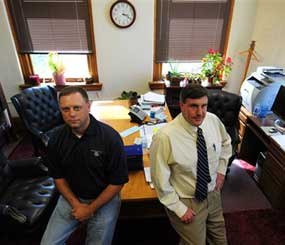 In this Monday, Aug. 3, 2009 photo, Centerville Police Chief Tom Demry, left, and Appanoose County Attorney Richard Scott, in Scott's office in Centerville, Iowa. (AP Photo)