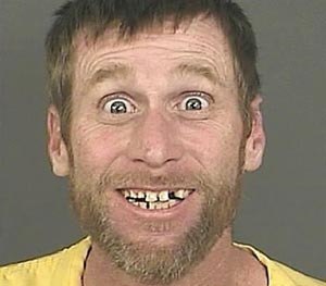 A Sept. 23, 2014 photo provided by the Denver District Attorney’s Office shows Michael Whitington with a broad, toothy smile and eyes open wide after his Sept. 23, 2014 arrest in Denver.