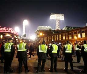 Law enforcement officials form a line along a street outside Fenway Park, background, following Game 6 of baseball's World Series between the Boston Red Sox and the St. Louis Cardinals in Boston. The Red Sox won 6-1 to win the series. (AP