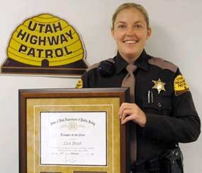 Utah Highway Patrol Officer Lisa Steed holds her award after being named Trooper of the Year.