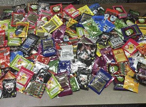 This photo provided Friday, Aug. 7, 2015 by New York Police Department shows packets of synthetic marijuana seized after a search warrant was served at a newsstand in Brooklyn, N.Y.
