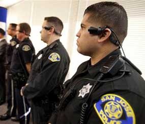 San Jose Police Department officers including Jessie Aragon, foreground, wear a video/audio recording device during a press conference at SJPD headquarters.