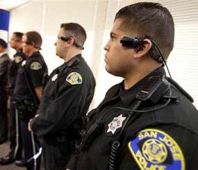 San Jose Police Department officers including Jessie Aragon, foreground, wear a video/audio recording device during a press conference at SJPD headquarters.