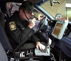 Pennsylvania State Police Trooper Thomas Carr demonstrates the new computer-equipped car. The new electronic system allows troopers to have instant access to national and state vehicle registration data and other critical information, plus they will be able to record information and prepare reports at the scene on the computers, instead of returning to the barracks to fill out paper forms. (AP Photo)