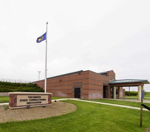 In this May 19, 2015, file photo, flags fly by the entrance to the Tecumseh State Correctional Institution in Tecumseh, Neb.
