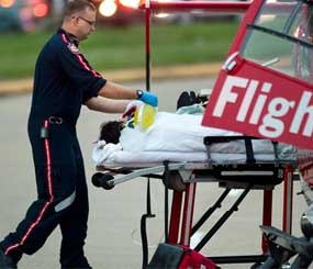A victim is taken to a LifeFlight helicopter in the aftermath of a shooting, Wednesday in Houston. Three people are dead and two have been airlifted to hospitals after gunfire erupted at a suburban Houston apartment complex Wednesday afternoon.