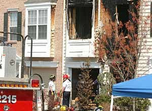 AP Photo/Brian Branch-PriceEvesham Township, N.J., firefighters remain at the scene following a fire in a three-story townhouse.