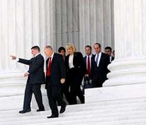 Arizona Gov. Jan Brewer, center, walks out after the Supreme Court in Washington, Wednesday, April 25, 2012, after the court's hearing on Arizona's