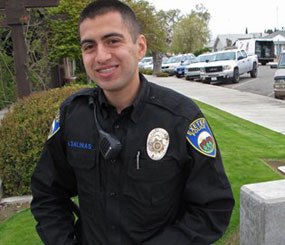 In this photo taken March 23, 2012, rookie police officer Alex Salinas, 22, poses at the police station in Exeter, Calif. On his second trip through high school, former C-student Alex Salinas got a lot of A's. He was 22, however, and an undercover narcotics officer going by the name Johnny Ramirez.
