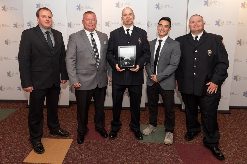Crewmembers who responded to the skydiving incident pose with the Ohio EMS Star of Life award.