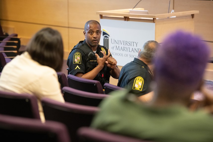 Pfc. Yale Partlow engages with the community members about new ideas for homeless outreach in Baltimore. (Photo/UMBPD)