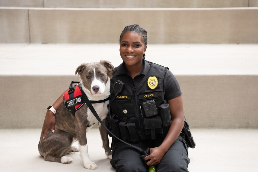 Officer Lexi poses with her human companion, UMBPD Comfort K-9 Officer Pfc. Kelli Blackwell. (Photo/UMBPD)