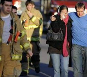 Firefighters and families gather at a staging area following the Sandy Hook shooting.