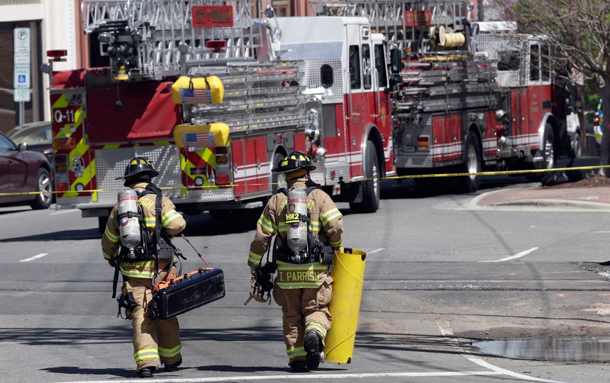Firefighters and emergency personnel work the scene of a building fire in downtown Durham, N.C., Wednesday, April 10, 2019. Authorities say emergency officials responded to an explosion and fire possibly caused by a gas leak.