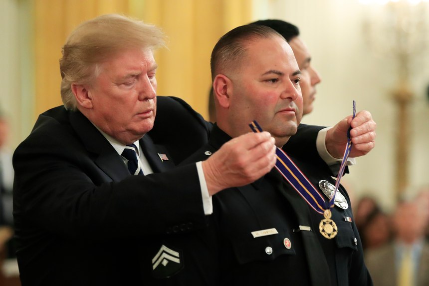 President Donald Trump awards Detective Manuel Campos of Irwindale (Calif.) Police Department, the Public Safety Officer Medal of Valor during a ceremony in the East Room of the White House in Washington, Wednesday, May 22, 2019.