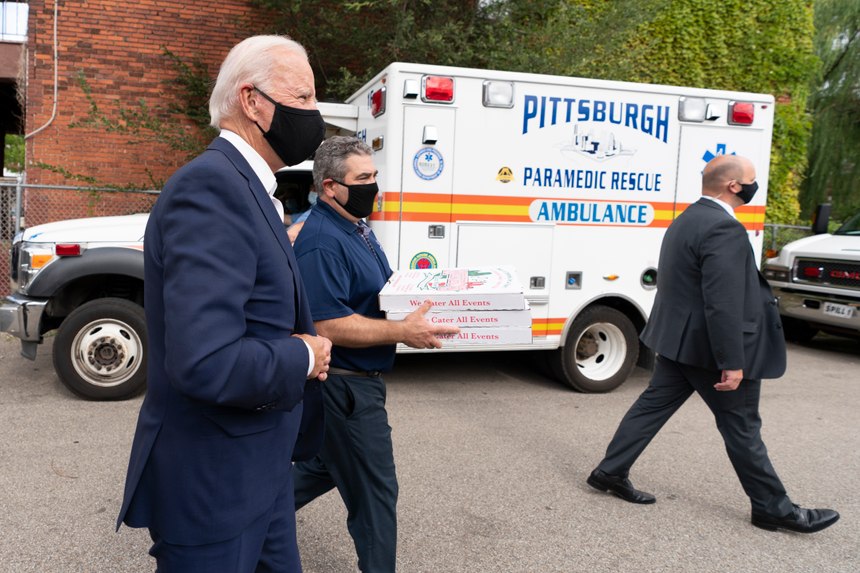 Democratic presidential nominee and former Vice President Joe Biden arrives with pizza as he visits Pittsburgh Fire Fighters IAFF Local No. 1 in Pittsburgh, Pa., Monday, Aug. 31, 2020. (AP Photo/Carolyn Kaster)